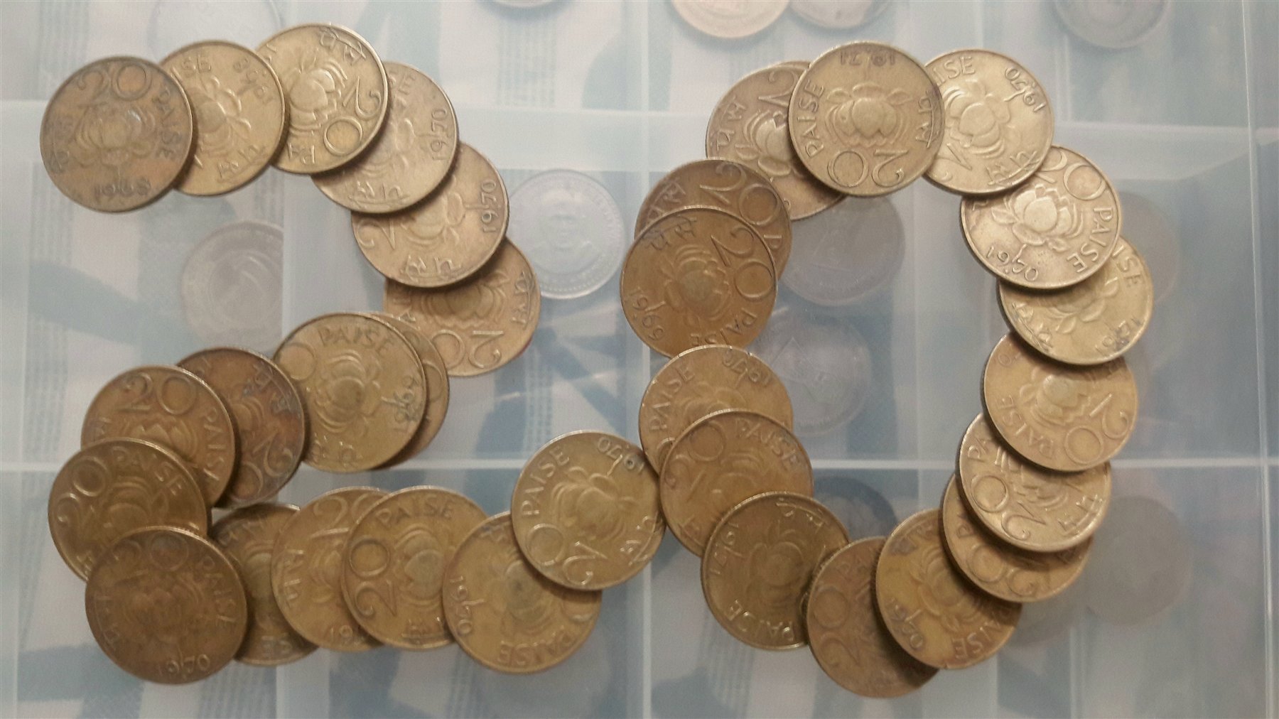 Indian twenty-paise coins arranged in the shape of the number twenty