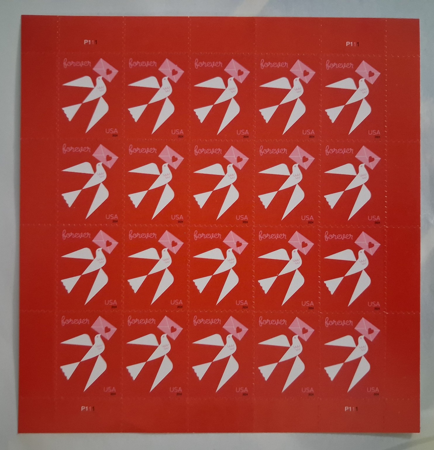 Red United States Love Forever stamp sheet with dove and envelope design